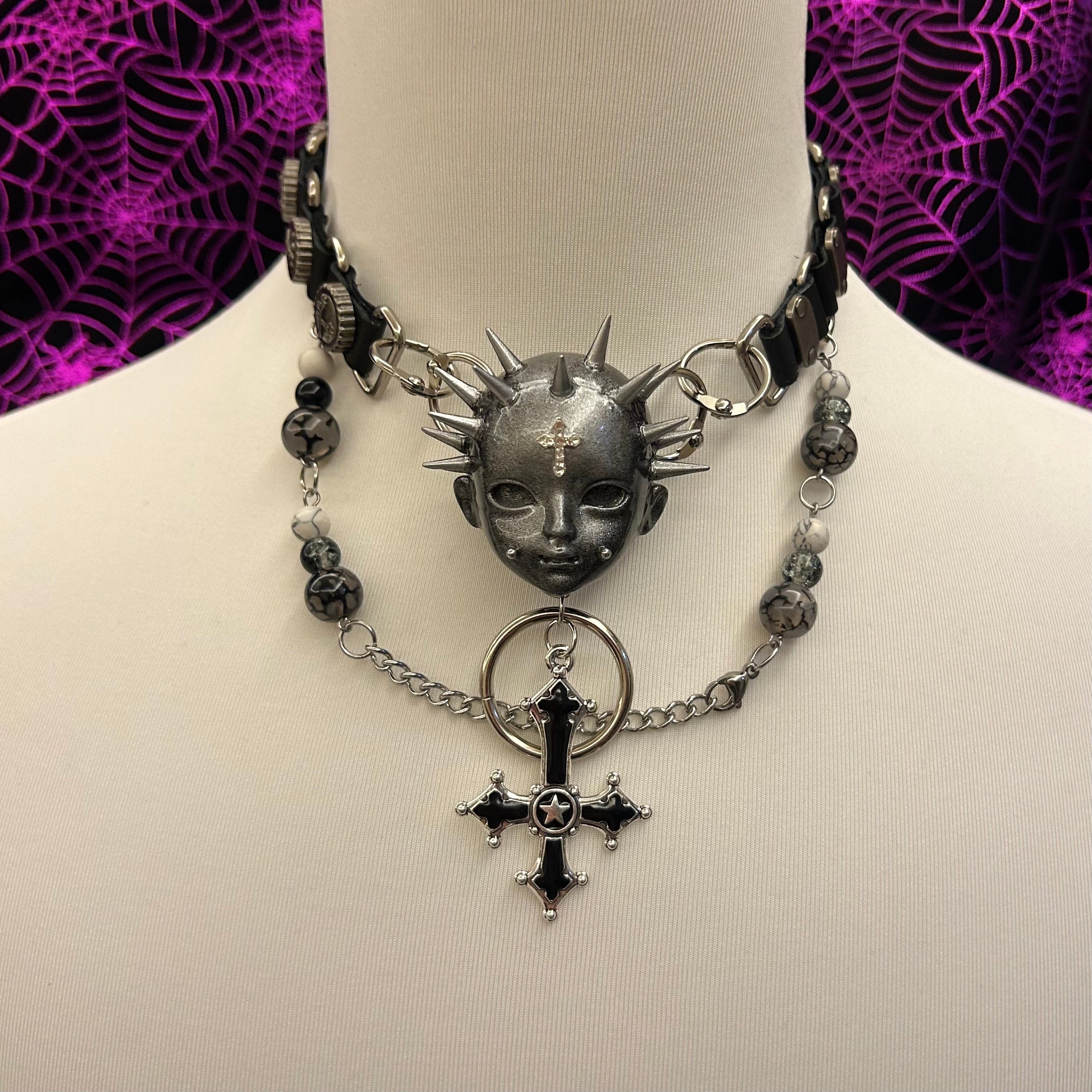 Black rivet cross necklace