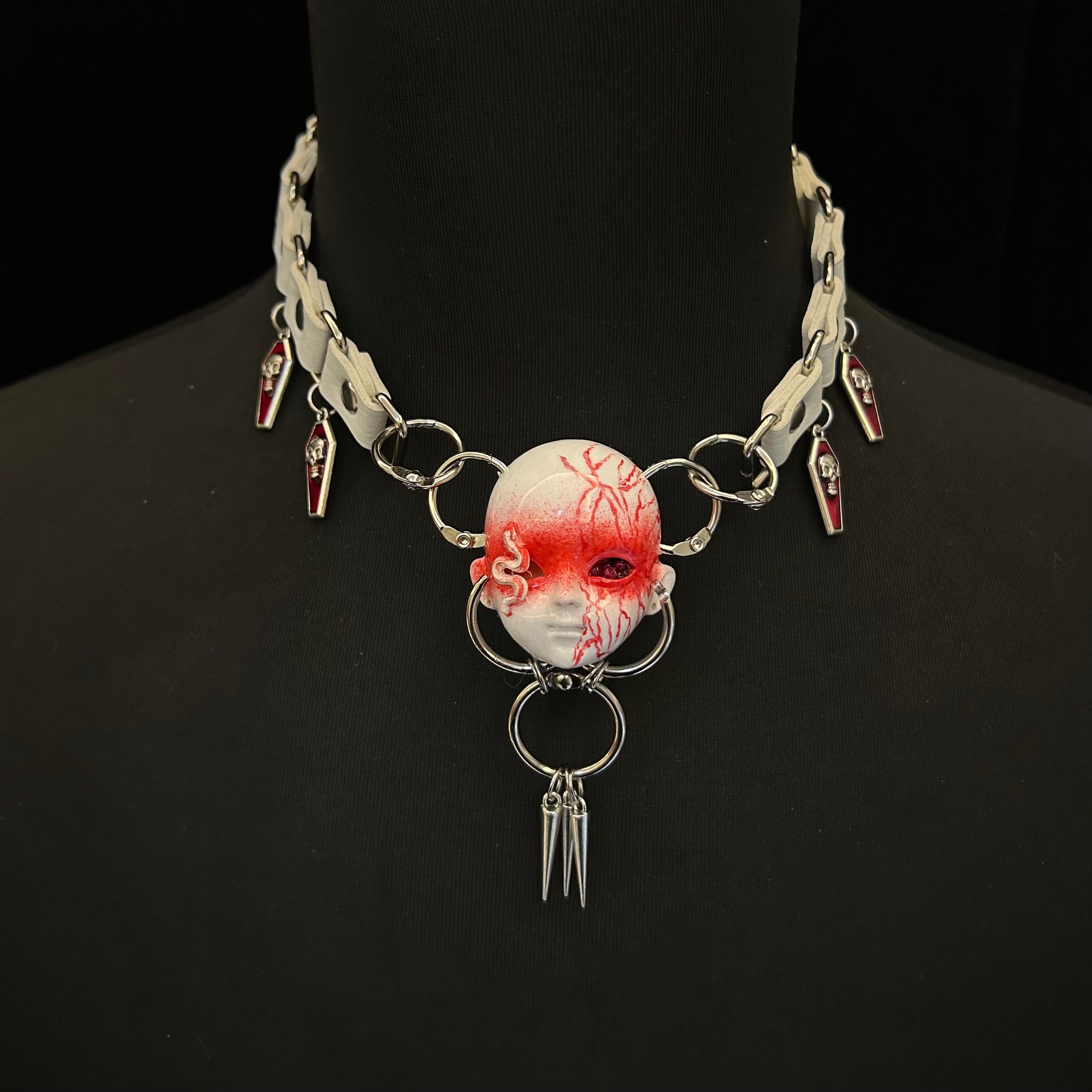 Snake element dark doll head necklace