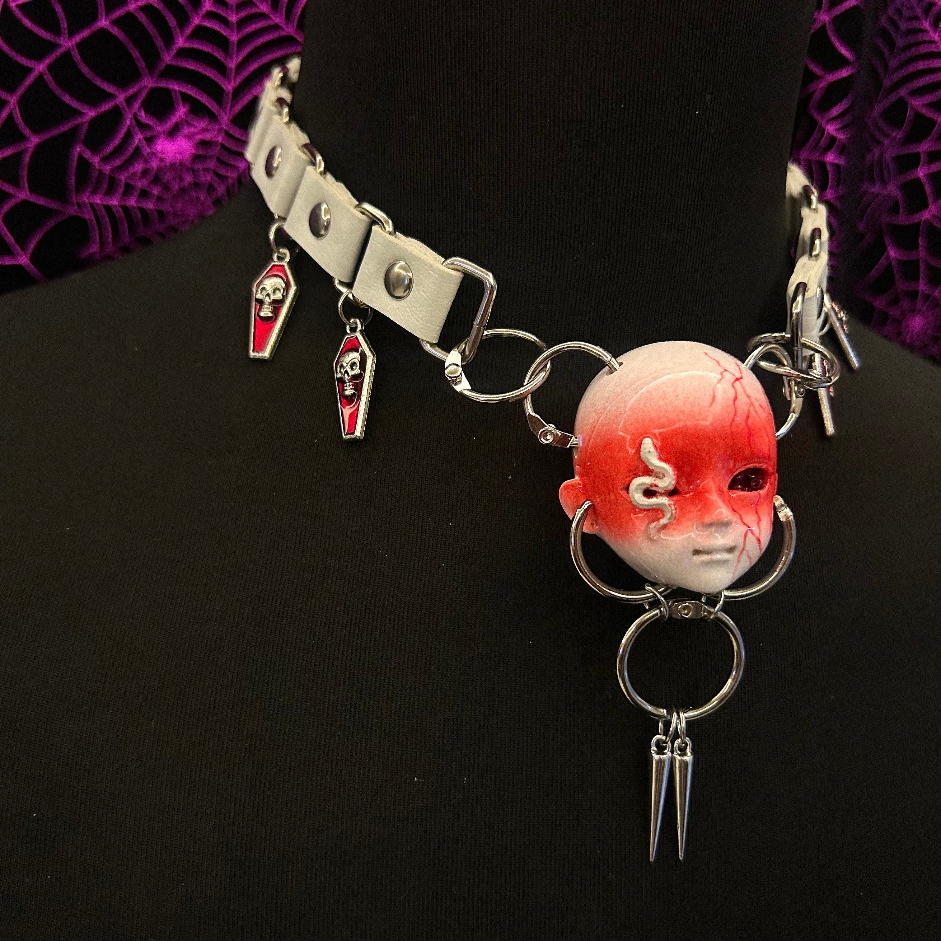 Snake element dark doll head necklace
