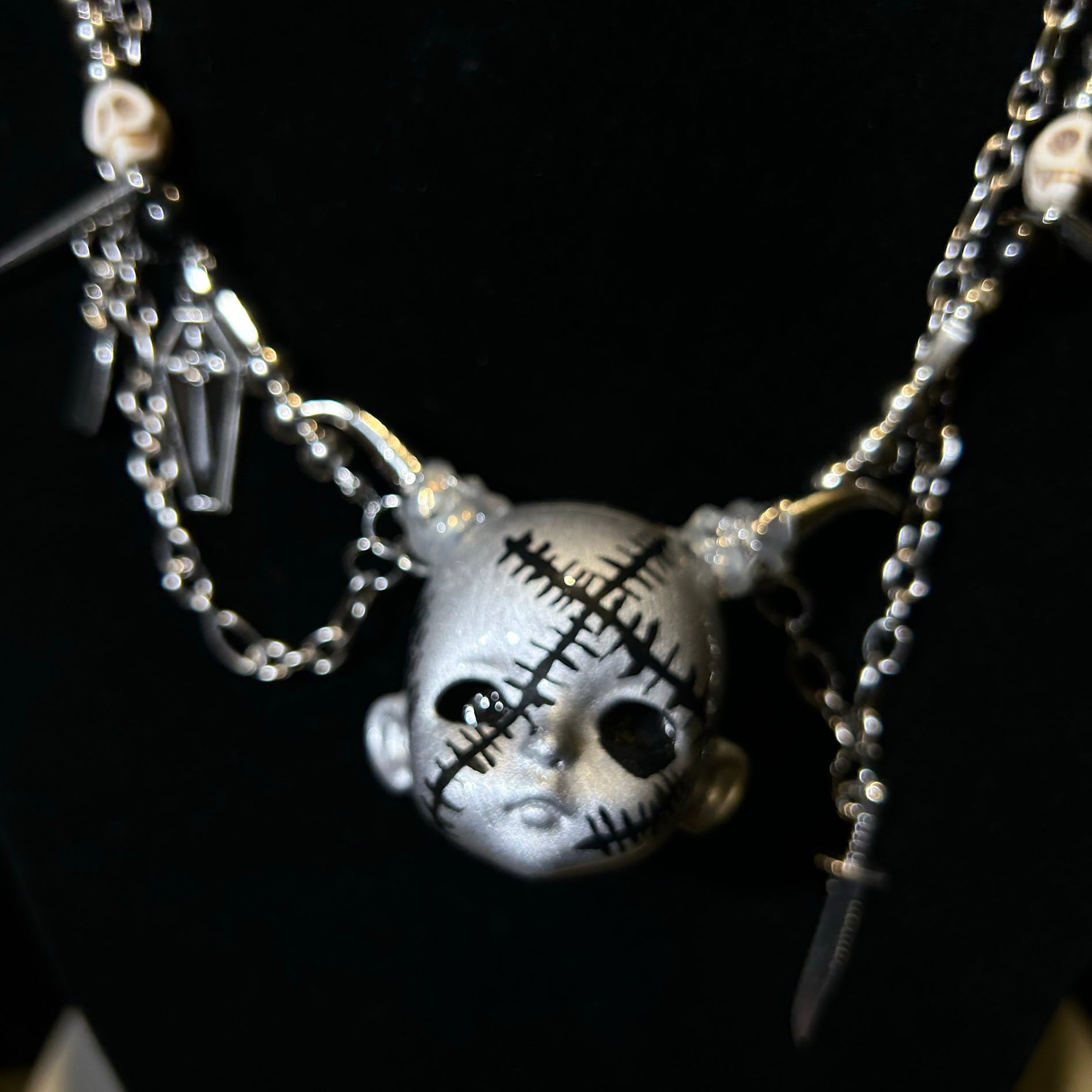 Silver scar baby head necklace