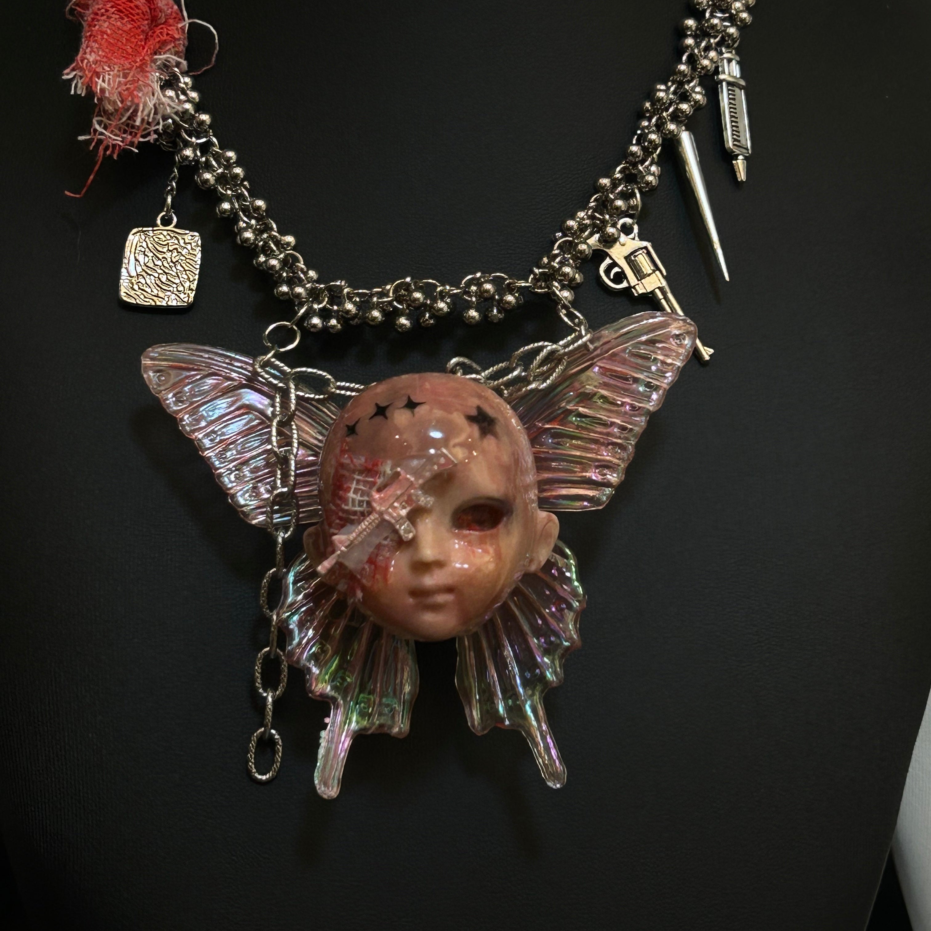 Battle-damaged version bandage doll head necklace